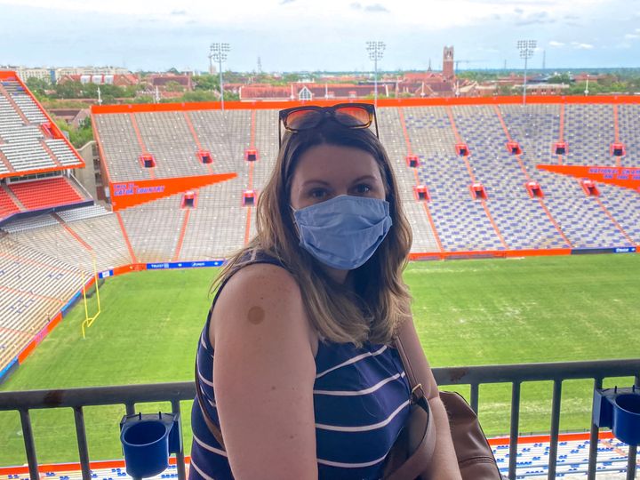 Elsbeth Russell waits after getting her COVID-19 vaccine at a stadium at the University of Florida.