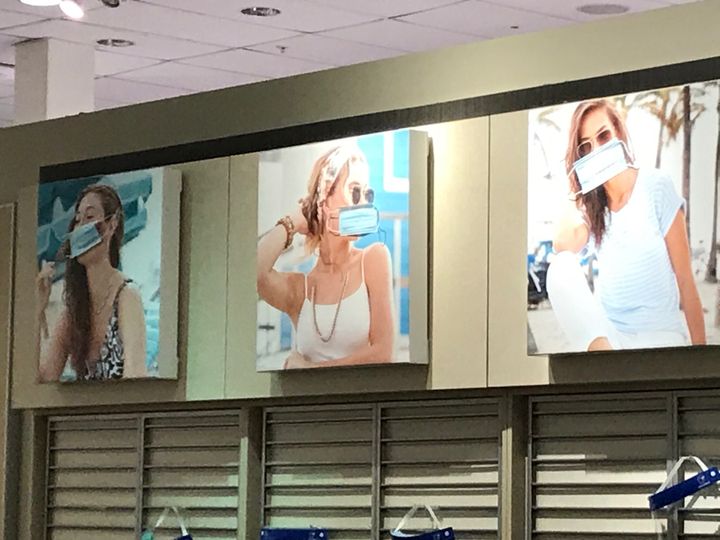Masks were placed over old photos of fashion models at the abandoned JCPenney where Udi Greenberg received a vaccine.