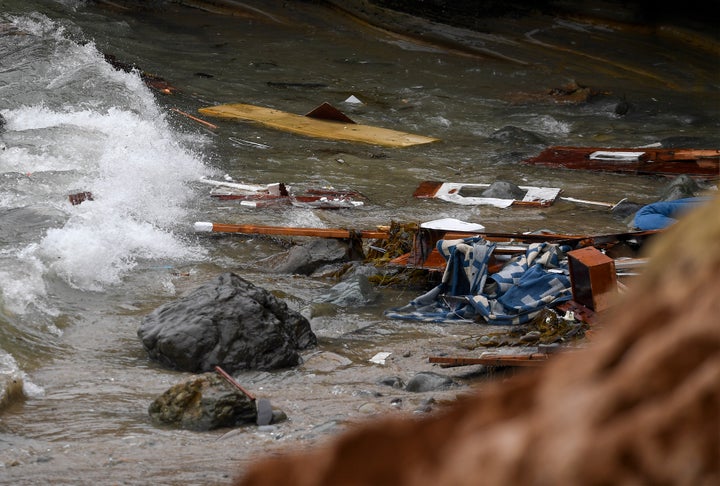 Wreckage and debris from a capsized boat washes ashore at Cabrillo National Monument near where a boat capsized just off the 