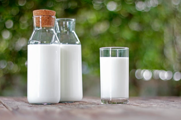 Milk bottle and milk glass on wooden table