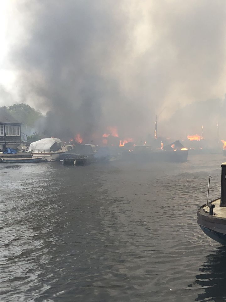 Handout photo taken with permission from the twitter feed of @drbouchard of a large fire that has broken out at Hampton Boat Sheds in Hampton, London. Picture date: Monday May 3, 2021.