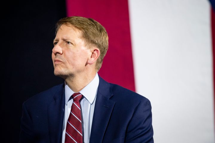Richard Cordray listens while former President Barack Obama speaks during a campaign rally at CMSD East Professional Center Gymnasium on Sept. 13, 2018, in Cleveland, Ohio.