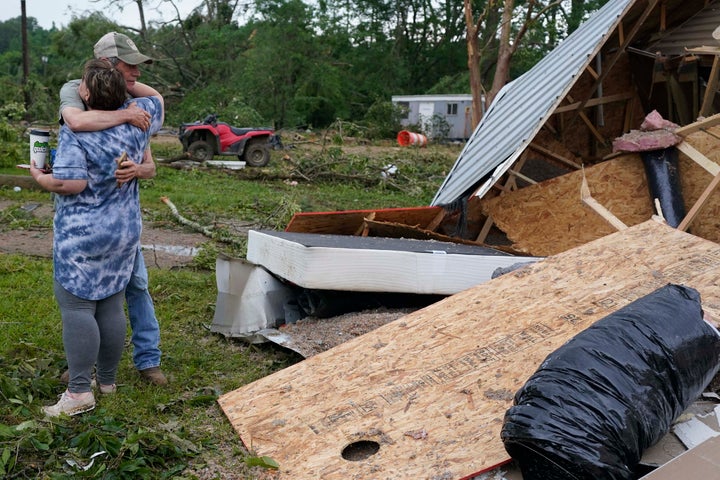 A neighbor hugs Vickie Savell next to the remains of her new mobile home early Monday, May 3, 2021, in Yazoo County, Miss.