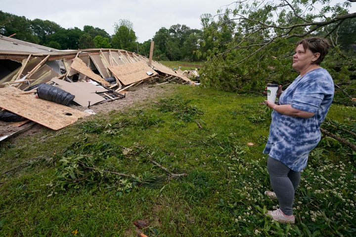 Vickie Savell looks at the remains of her new mobile home early Monday, May 3, 2021, in Yazoo County, Miss.