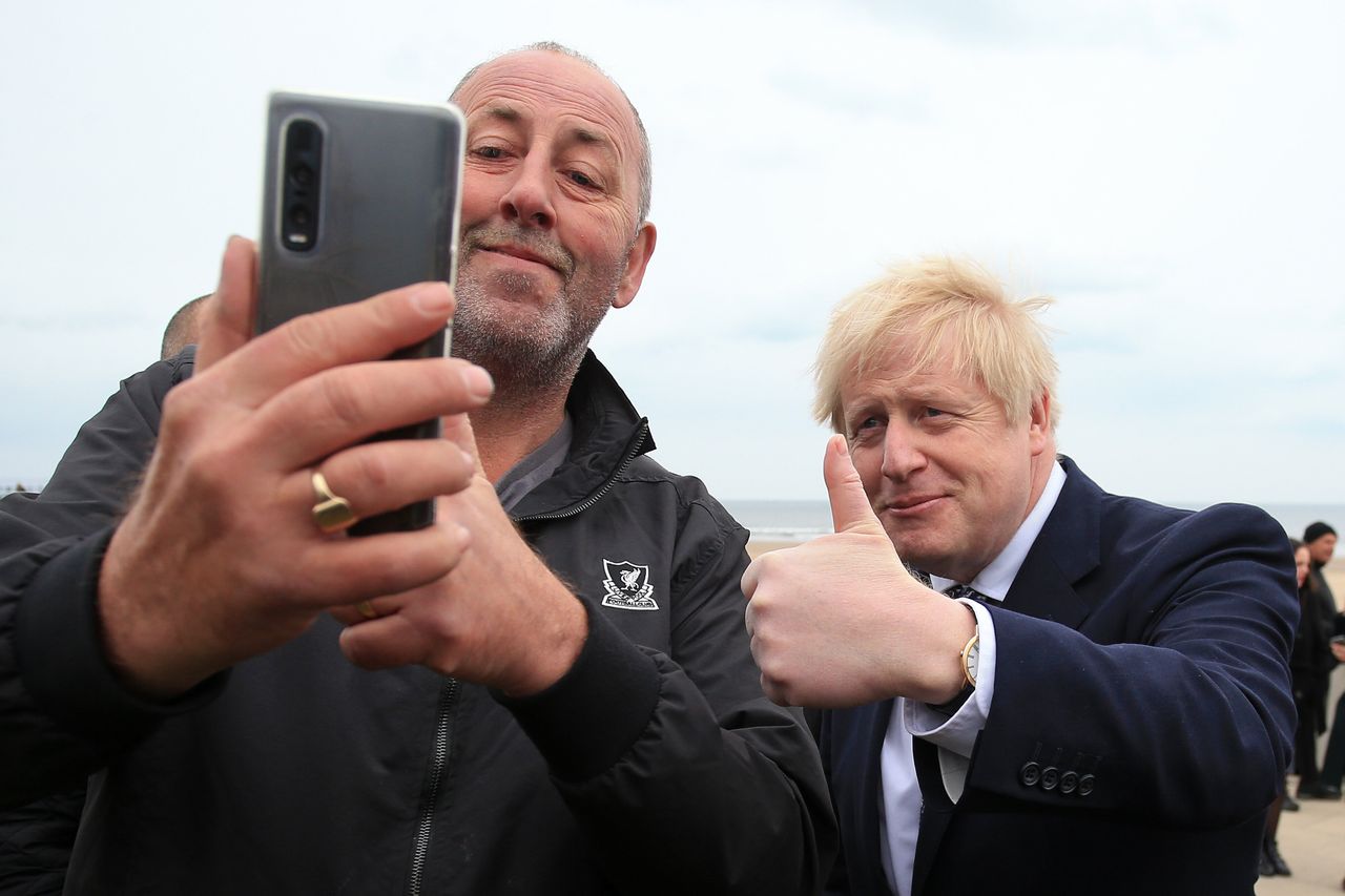 Boris Johnson poses for a "selfie" photograph as he meets members of the public while campaigning in Hartlepool