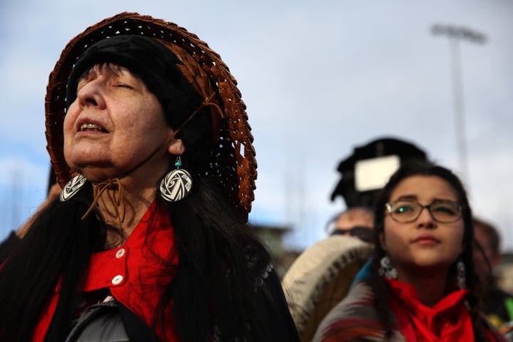 Ellany Kayce of Tlingit Nation closes her eyes and listens to a song performed by members of the Native community before thousands march through the streets of Seattle. The march was led by families of missing or murdered indigenous women.