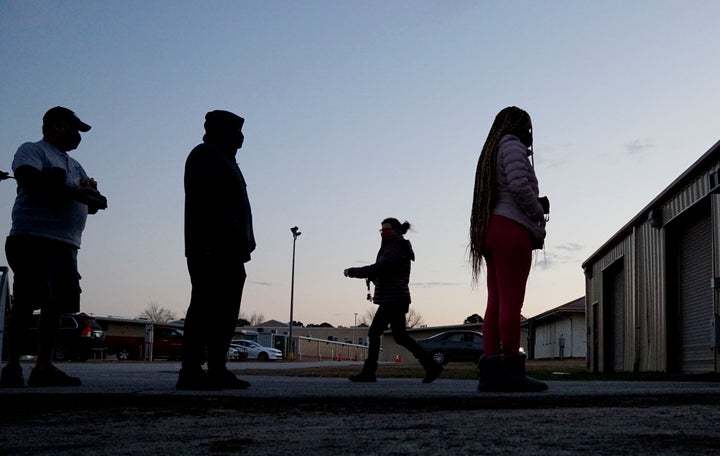 Voters stand in line at a polling station at the Gwinnett County Fairgrounds on Jan. 5, 2021, in Lawrenceville, Georgia. 
