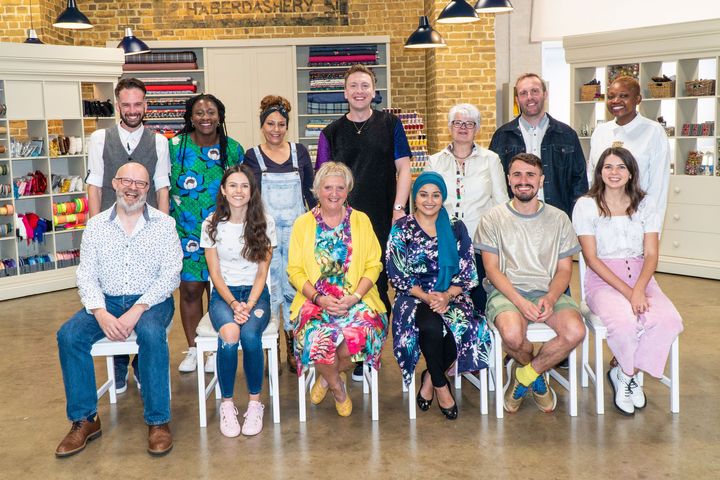 The cast of this year's Great British Sewing Bee posing with host Joe Lycett