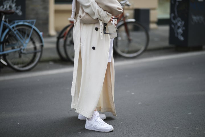 Lou Beyer wearing beige Bottega Veneta leather bag, white Nike Air Force 1 sneakers and beige Acne Studios trenchcoat on March 25 in Cologne, Germany.