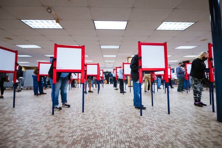 Voters stand at ballot boxes and cast their votes at Fairdale High School on Nov. 3, 2020, in Louisville.