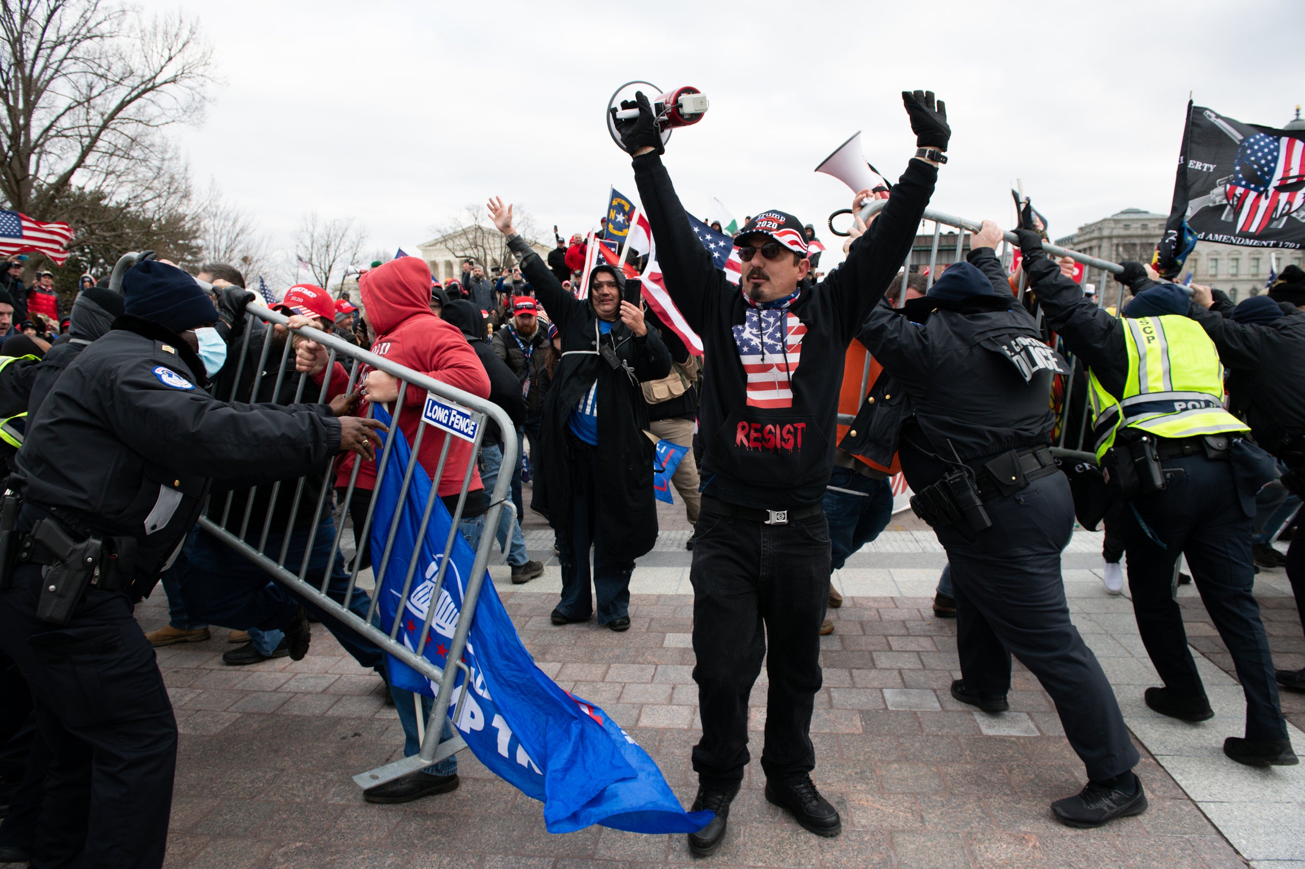 Demonstrators breach security fencing during a protest outside the U.S. Capitol in Washington, D.C., U.S., on Wednesday, Jan.