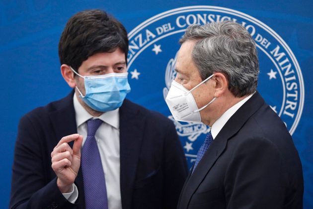 Italy's Prime Minister, Mario Draghi (R) and Italy's Health Minister, Roberto Speranza talk after holding...