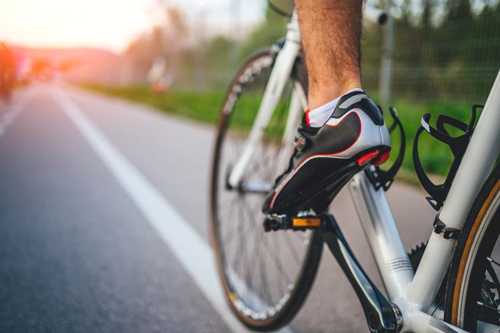 Cycling sport, feet on pedal of bicycle.
