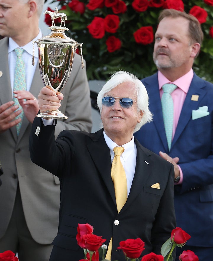 Trainer Bob Baffert raises the trophy after winning the 147th running of the Kentucky Derby with Medina Spirit, his seventh career Derby win.