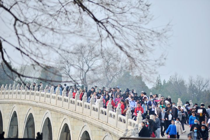BEIJING, CHINA - MARCH 27, 2021 - Crowds of tourists enjoy flowers and take photos in front of the Happy Shou Hall at the Summer Palace in Beijing, China, March 27, 2021. (Photo credit should read Costfoto/Barcroft Media via Getty Images)