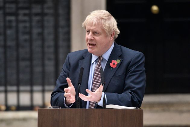 Prime Minister Boris Johnson gestures as he addresses the nation at 10 Downing Street 