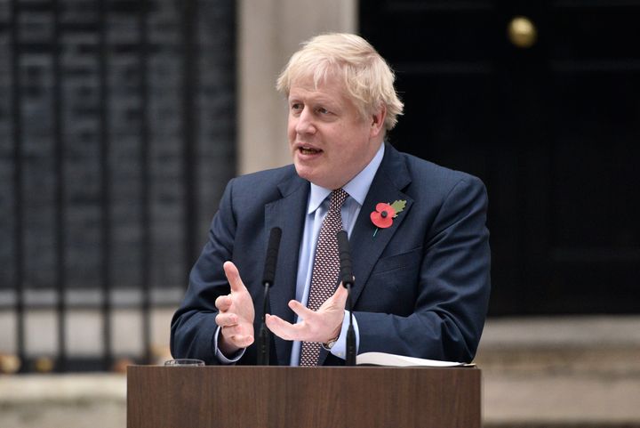 Prime Minister Boris Johnson gestures as he addresses the nation at 10 Downing Street 