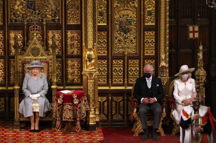 Queen Elizabeth sits on the The Sovereign's Throne in the House of Lords chamber with Prince Charles and Camilla, Duchess of Cornwall, sat to her side, during the State Opening of Parliament London on May 11.