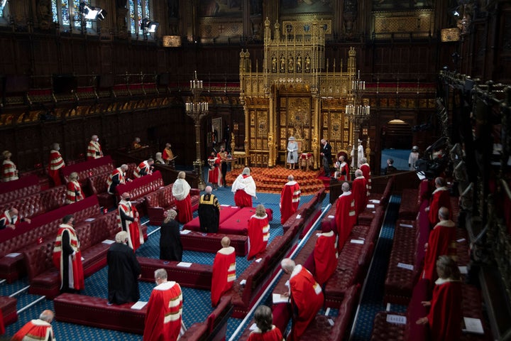 Queen Elizabeth II reacts after reading the Queen's Speech on the The Sovereign's Throne in the House of Lords chamber.