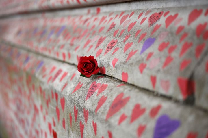 A red rose is attached to the National Covid Memorial Wall on the embankment on the south side of the River Thames in London