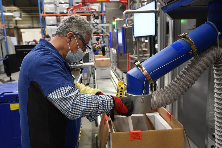 An employee works at a Pfizer pharmaceutical factory in Belgium in April. Big Pharma and its opponents agree that an IP waive