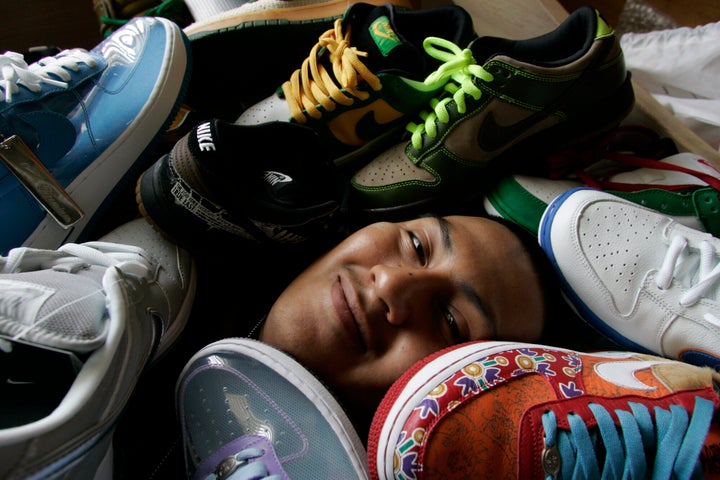 Cesar Vasquez, who owns 300 pairs of limited-edition sneakers, is photographed at his Los Angeles home with some of them. He often camps outside sneaker boutiques to get rare shoes, which he then resells on eBay for triple the price.