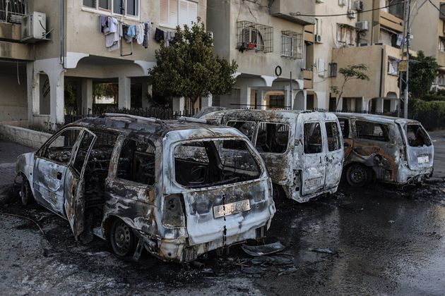 12 May 2021, Israel, Lod: Burnt vehicles are seen after the riots in the city of Lod, following the funeral...