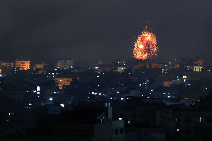 An explosion lights the sky following an Israeli airstrike on Beit Lahia in the northern Gaza Strip on May 14, 2021.