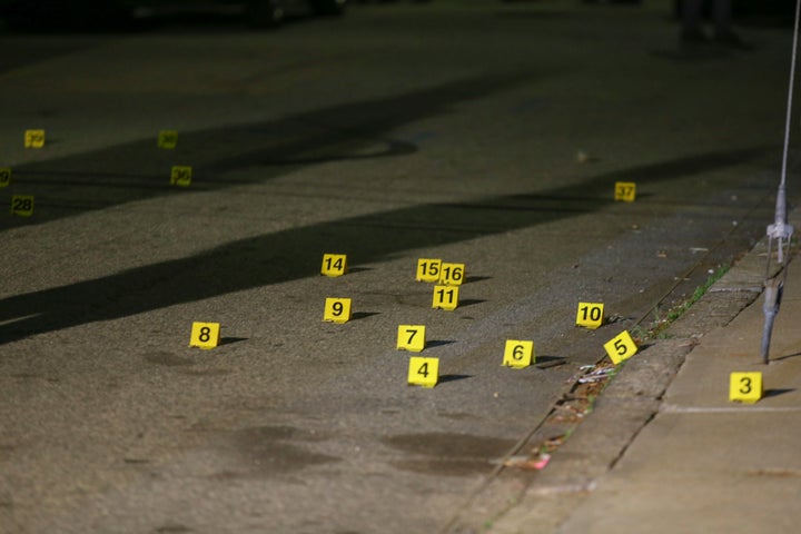 Evidence markers line the street outside a house on Carolina Avenue after a shooting, late Thursday, May 13, 2021, in Providence, R.I. (AP Photo/Stew Milne)