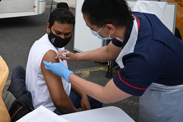 A member of the public receives a Covid-19 vaccine at a temporary vaccination centre at the Essa academy in Bolton.
