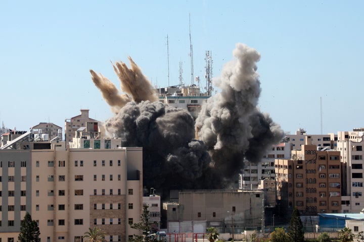 A thick column of smoke rises from the Jala Tower as it is destroyed in an Israeli airstrike in Gaza City on Saturday. 