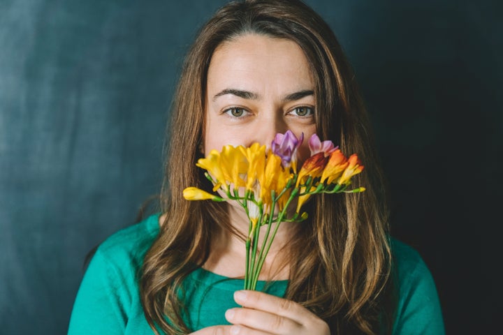 Female smelling bunch of fresh spring flowers