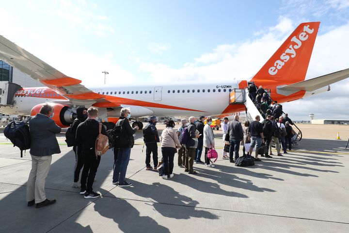 Passengers prepare to board an easyJet flight to Faro, Portugal, at Gatwick Airport on Monday