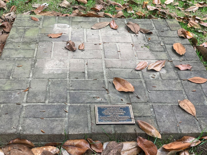 A brick base sits empty Tuesday, April 13, 2021, where chair carved out of limestone honoring Confederate President Jefferson Davis was stolen from Confederate Memorial Circle, a private section of Live Oak Cemetery in Selma, Ala. Police recovered the chair in New Orleans. (AP Photo/Kim Chandler)