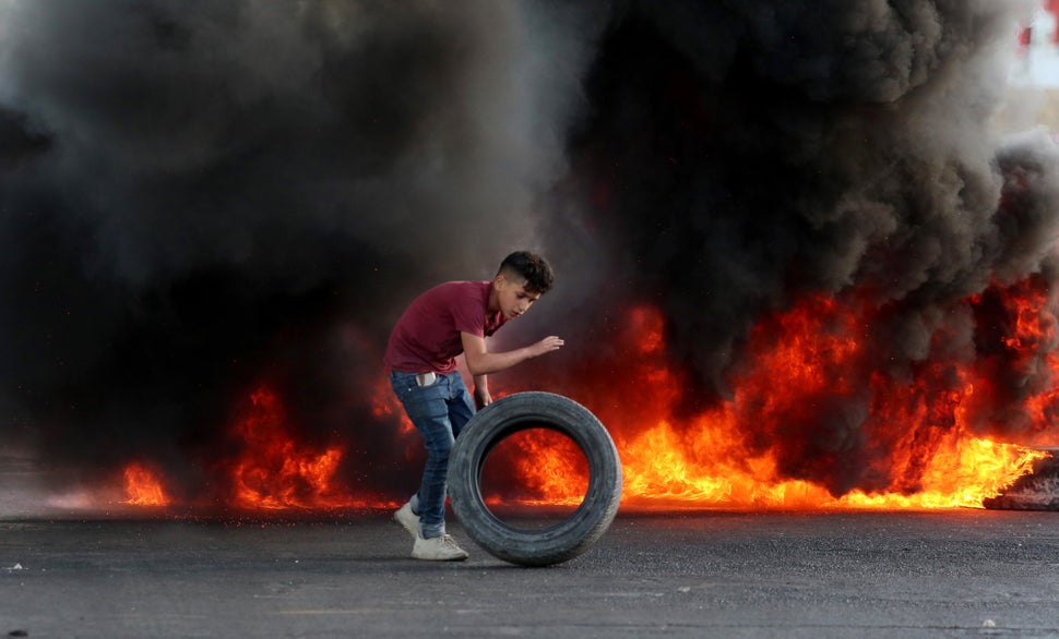 Nablus, Cisgiordania. Un giovane palestinese dà fuoco alle gomme in risposta all'intervento delle forze...