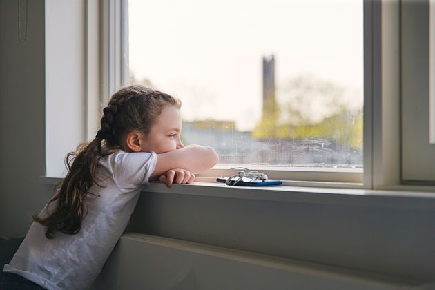 Fed up girl looking out of window