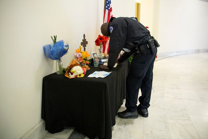 A U.S. Capitol Police officer signs a memorial book for Capitol Police Officer Howard Liebengood on Jan. 12, 2021. Liebengood