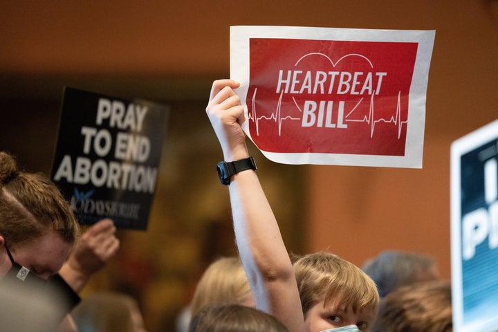 A demonstrator in Columbia, South Carolina, in February holds up a sign in favor of the state's six-week abortion ban.