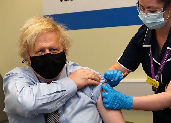 Boris Johnson receives the first dose of the AstraZeneca vaccine administered by nurse and clinical pod lead, Lily Harrington at St.Thomas' Hospital on March 19