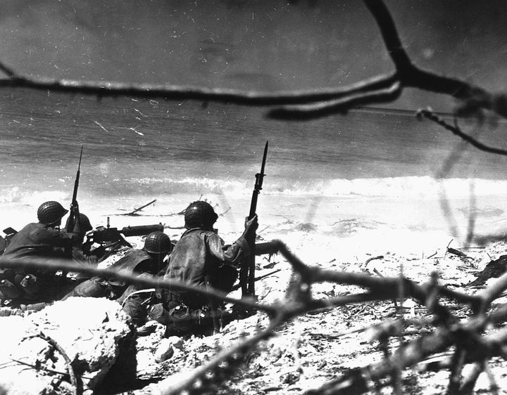 Marines of the 22nd Regiment aim machine gun fire at a Japanese target 400 yards up the beach at Eniwetok during an attack that took place February 18-21, 1944. (Photo by © CORBIS/Corbis via Getty Images)