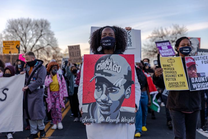 Demonstrators hold posters of Daunte Wright during a protest near the Brooklyn Center Police Department in Minnesota on April 16.