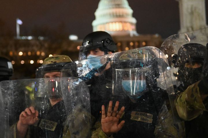 National Guard troops clear a street outside the Capitol building on Jan. 6.