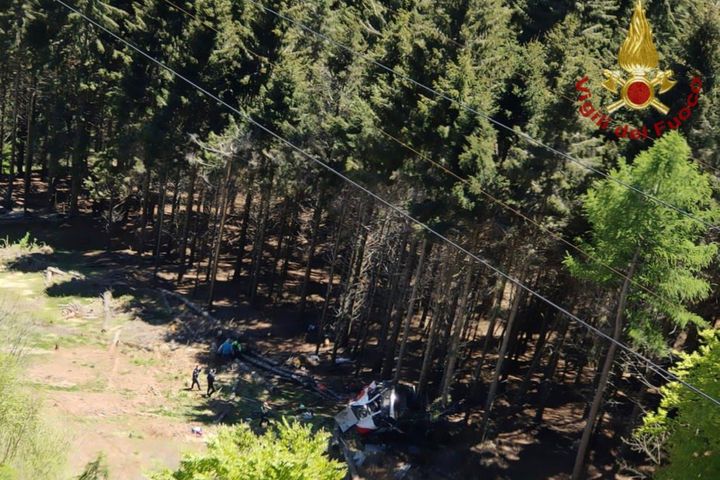 The wreckage of a cable car is seen on the ground after it collapsed near the summit of the Stresa-Mottarone line in the Pied