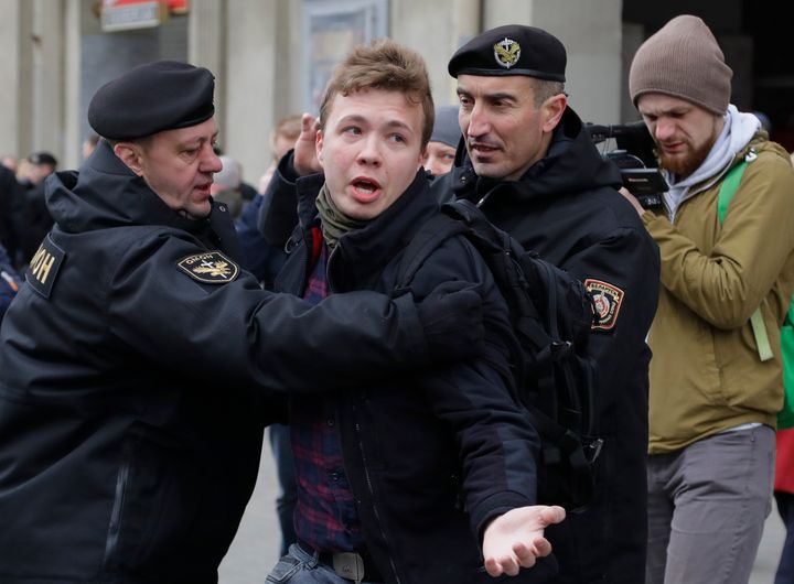 In this Sunday, March 26, 2017 file photo, Belarus police detain journalist Raman Pratasevich, center, in Minsk, Belarus. Raman Pratasevich, a founder of a messaging app channel that has been a key information conduit for opponents of Belarus’ authoritarian president, has been arrested after an airliner in which he was riding was diverted to Belarus because of a bomb threat. The presidential press service said President Alexander Lukashenko personally ordered that a MiG-29 fighter jet accompany the Ryanair plane — traveling from Athens, Greece, to Vilnius, Lithuania — to the Minsk airport. (AP Photo/Sergei Grits, File)