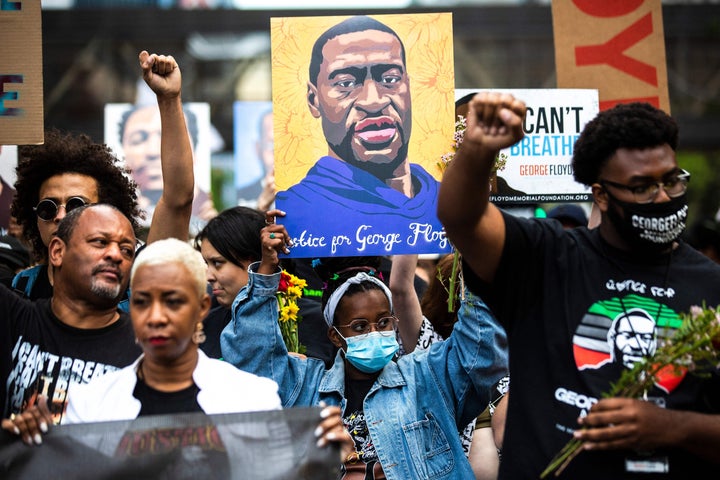 People raise their fists as they march during an event in remembrance of George Floyd in Minneapolis, Minnesota, on May 23, 2