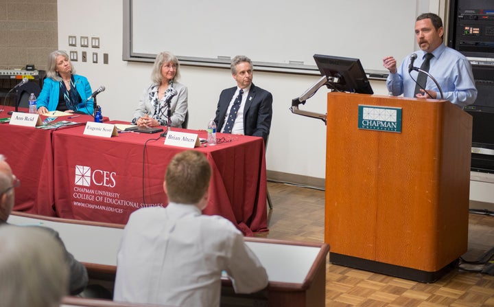 Climate change and atmospheric scientist Ben Santer, at the podium on the right, speaks during open panel discussion on evolution and climate change at Chapman University. 