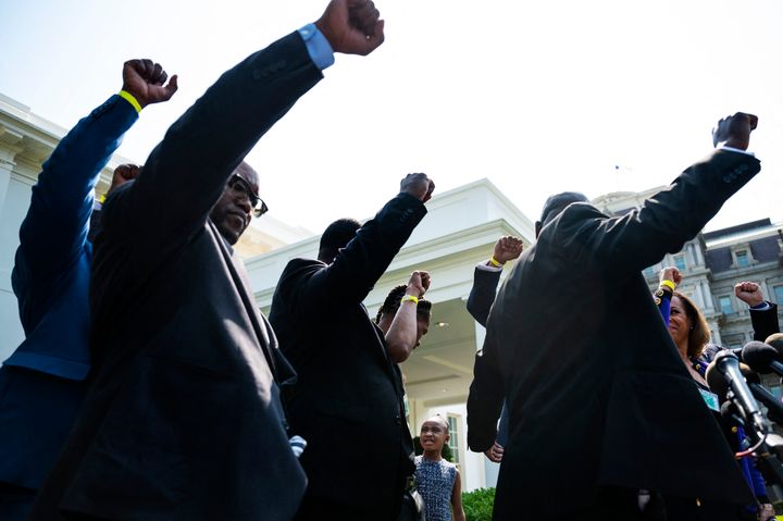 George Floyd's family and their lawyer Ben Crump, right, hold up their fists outside the White House as Floyd's daughter Gianna Floyd calls out, "Say his name," after meeting with President Joe Biden on Tuesday.