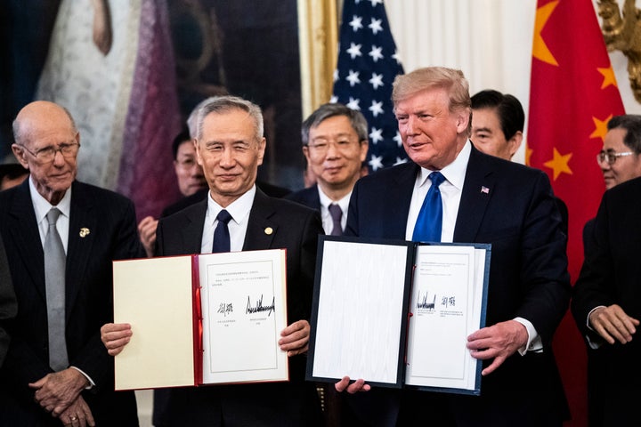 Donald Trump signs a trade agreement with Chinese Vice Premier Liu He in the East Room at the White House on Jan. 15, 2020, i