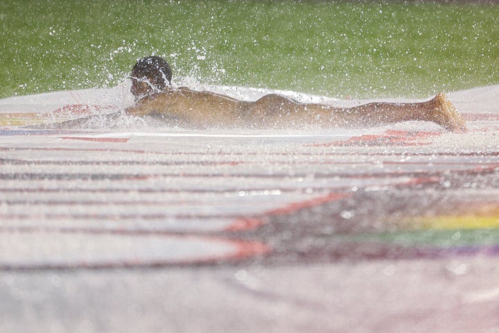 A streaker slides on the infield tarp during a rain delay between the Cincinnati Reds and against the Washington Nationals at Nationals Park on May 26 in Washington.