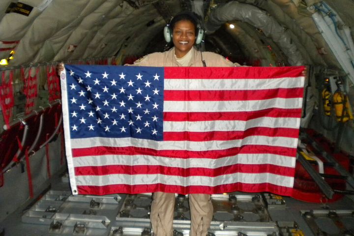Retired Air Force Lt. Col. Stephanie Davis holds a U.S. flag in the cargo area of a KC-135 airplane while flying over Pakistan/Afghanistan. For Davis, who grew up poor, the military was a path to the American dream, a realm where everyone would receive equal treatment. But many of her service colleagues, Davis says, saw her only as a Black woman. Or for the white resident colleagues who gave her the call sign of ABW â it was a joke, they insisted â an âangry black woman,â a classic racist trope. (Courtesy Stephanie Davis via AP)